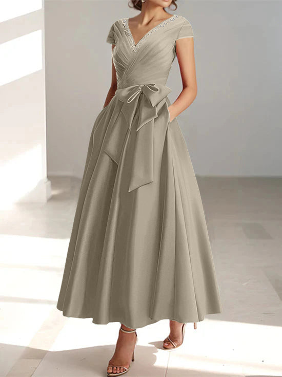Sage green a-line midi dress with v-neck, short sleeves, and pockets