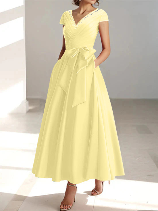 Pale yellow a-line midi dress with v-neck, short sleeves, and side pockets