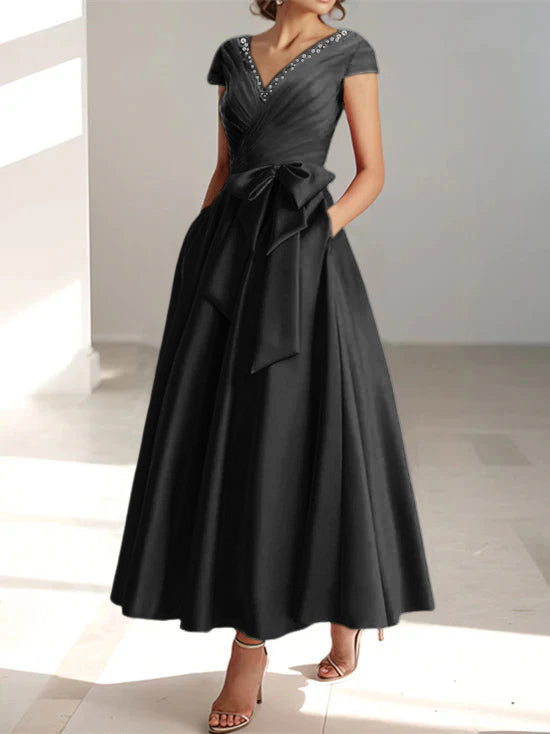 Black A-line midi dress with V-neck, short sleeves, and side pockets